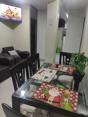 a dining room table with two mats on it at Depawanka 1 departamento amoblado in Huancayo