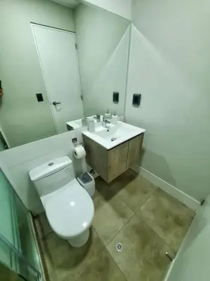 a bathroom with a white toilet and a sink at Apartamento estreno céntrico y moderno in Lima