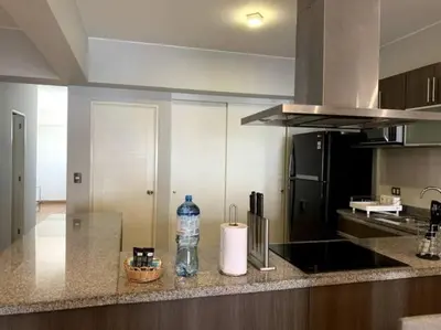 a kitchen with a bottle of water on a counter at MLA apartments - Larcomar in Lima