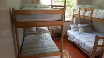 two bunk beds in a room with a window at casa campestre marina in Chaclacayo