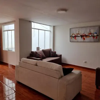a living room with a couch and two couches at Apart Hotel Cabral in Lima