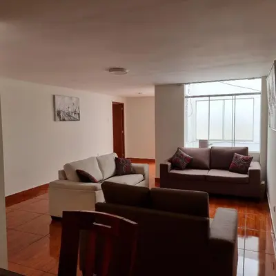 a living room with two couches and a couch at Apart Hotel Cabral in Lima