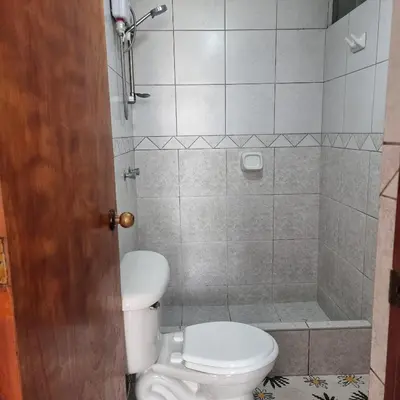 a bathroom with a toilet and a shower at Apart Hotel Cabral in Lima