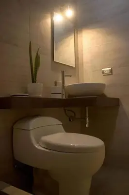 a bathroom with a white toilet and a sink at Hostel Willys House in Paracas