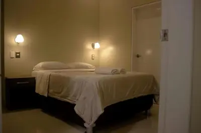 a bedroom with a bed with two towels on it at Hostel Willys House in Paracas