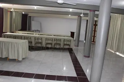 a banquet hall with tables and chairs and a ceiling at Embassy Beach in Pisco