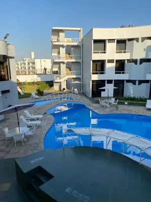 a swimming pool in the middle of a building at Embassy Beach in Pisco