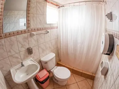a bathroom with a toilet and a sink and a shower at Eco Home View - Guest House in Cusco