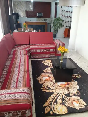 a living room with a red couch and a table at WAYRA APART HOTEL in Cusco