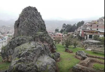 a large rock sitting on top of a city at WAYRA APART HOTEL in Cusco