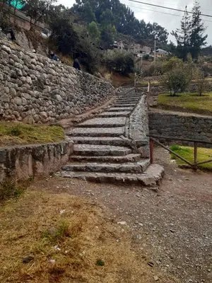 a set of stone steps in front of a stone wall at WAYRA APART HOTEL in Cusco