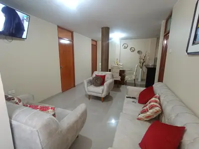 a living room with a couch and two chairs at LUANA’S HOUSE in Ica