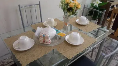 a glass table with two pairs of baby shoes on it at LUANA’S HOUSE in Ica