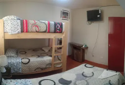 a small room with a bunk bed and a tv at LUANA’S HOUSE in Ica