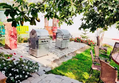 two stove tops sitting on a patio in a yard at Hotel Viñas del Sol Eterno in Chincha Alta