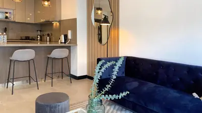 a living room with a blue couch and a bar at Navarrete by Wynwood House in Lima