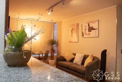a living room with a couch and a table at Beautiful apartment Near airport /cozy Oceanfront in Lima