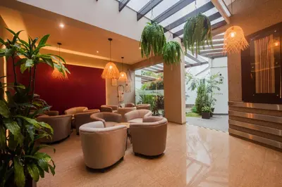 a waiting room with a bunch of chairs and plants at El Tambo 1 in Lima