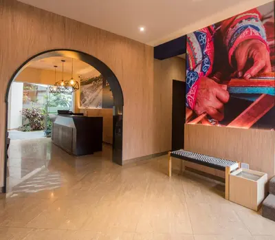 a lobby with a large painting on the wall at El Tambo 1 in Lima