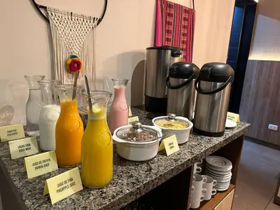 a counter with bottles of orange juice and other items at El Tambo 1 in Lima