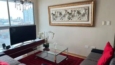a living room with a couch and a glass table at HABITACIÓN EN EDIFICIO CENTRO COLONIAL- Cerca al centro histórico in Lima