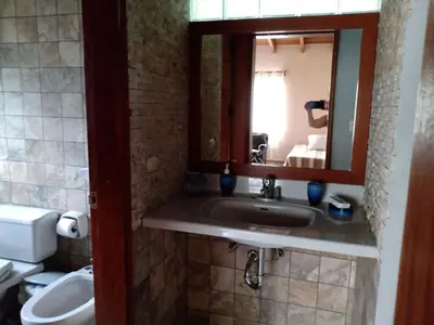 a bathroom with a sink and a mirror and a toilet at Casa El Palto in Santa Eulalia