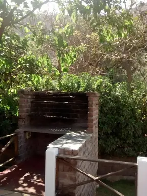 a brick bench sitting in front of a hedge at Casa El Palto in Santa Eulalia