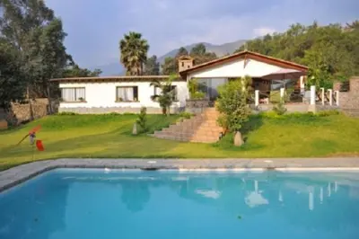 a house with a swimming pool in front of a house at Casa El Palto in Santa Eulalia