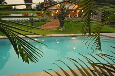 a palm tree in front of a house with a swimming pool at Casa El Palto in Santa Eulalia