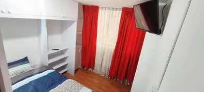 a bedroom with a red curtain and a tv at IV Hermosa Habitacion Privada en Miraflores City in Lima
