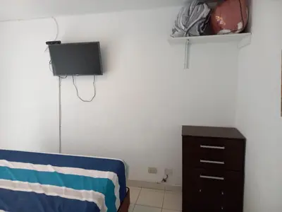 a bedroom with a bed and a dresser and a tv at Minidepartamento en San Bartolo - VISTA AL MAR in San Bartolo