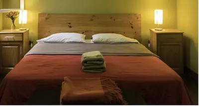 a bedroom with a large bed with towels on it at Casa Nuestra Peru in Lima