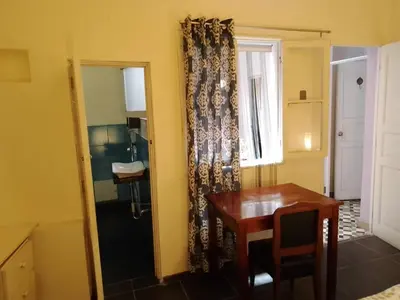 a dining room with a table and a window at Casa Nuestra Peru in Lima