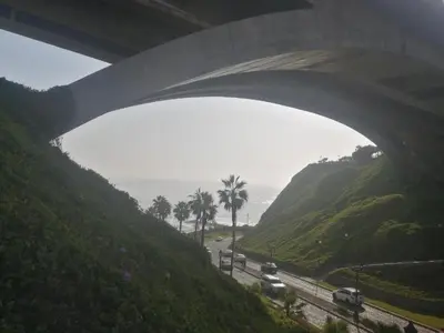 a highway under a bridge with cars on the road at Centric, private, petfriendly apartments in Miraflores in Lima