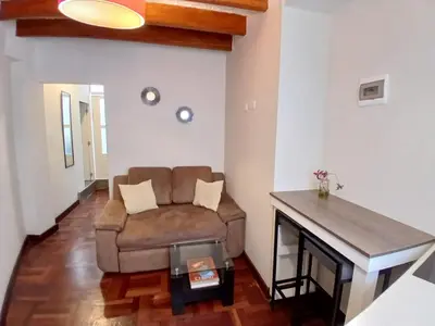 a living room with a couch and a table at Centric, private, petfriendly apartments in Miraflores in Lima