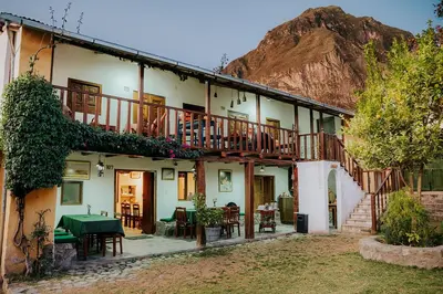 a building with a table and chairs in front of it at Hotel Vallehermoso in Cotahuasi