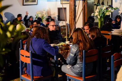a group of people sitting at a table in a restaurant at Hotel Vallehermoso in Cotahuasi