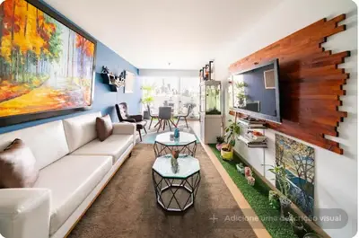 a living room with a white couch and a tv at Precioso cuarto dentro de un apartamento centrico compartido in Lima