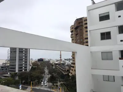 a view of a city from a white building at Precioso cuarto dentro de un apartamento centrico compartido in Lima