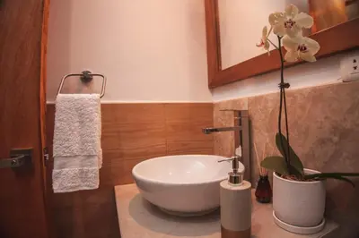 a bathroom with a white sink and a mirror at Florez de la Villa in Huaran