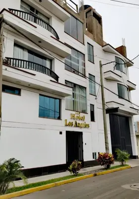 a white building with a hotel sign on it at Hotel los angeles in Huaral