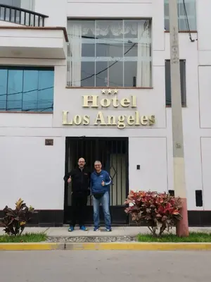 two men standing in front of a hotel los angeles at Hotel los angeles in Huaral