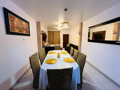 a dining room with a table with yellow plates on it at Casa de Playa Barranca in Barranca