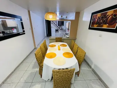 a dining room with a white table and chairs at Casa de Playa Barranca in Barranca