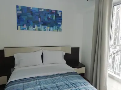 a bedroom with a bed with a painting above it at Lindo y Espacioso Departamento muy cerca a Miraflores in Lima