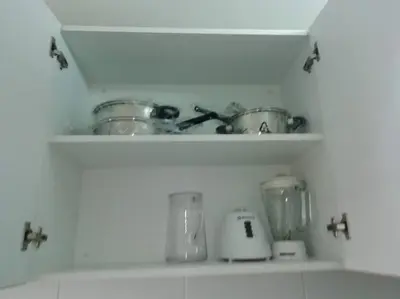 a kitchen shelf with pots and pans on it at Lindo y Espacioso Departamento muy cerca a Miraflores in Lima