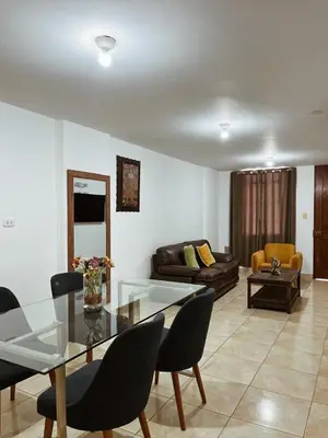 a living room with a glass table and a couch at MH Apartments Ica in Ica