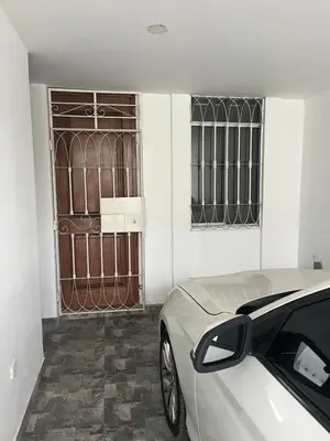a white car parked in front of a door at MH Apartments Ica in Ica