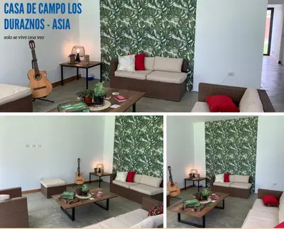 a living room with a couch and a table with a guitar at Country House In Asia in Asia