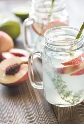 a glass jar filled with liquid with fruit in it at Country House In Asia in Asia
